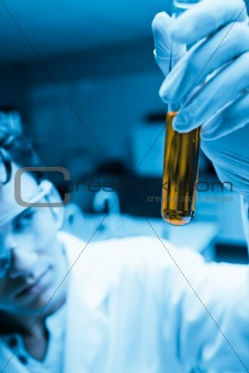 Portrait of a male scientist looking at a test tube