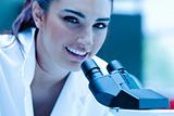 Young scientist posing with a microscope