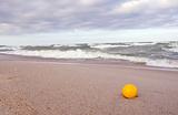 yellow ball on the sea beach sand