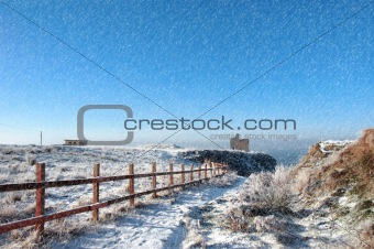 fenced walk to ballybunion castle in blizzard