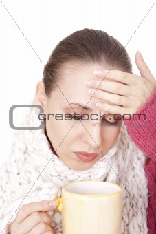 Sick woman with cup in winter scarf
