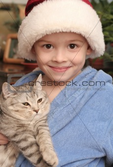 The happy boy with a grey kitten in hands