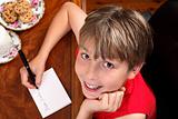 Child writing  a letter or card at Christmas