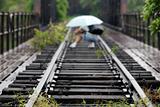 people taking photo along the deserted railway track