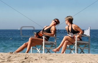 Two Women Reading On The Beach
