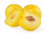 Yellow plums with halves on white