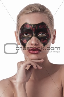 pretty girl with carnival mask painted on face