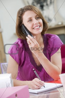 Woman at her desk talking on phone