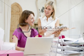 Women looking at paperwork together