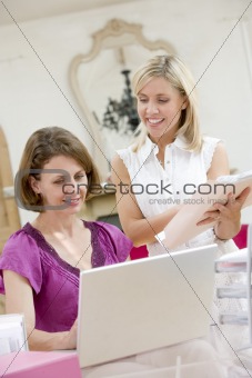 Women looking at laptop together