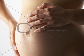 Detail Of Pregnant Woman Holding Stomach