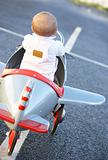 Baby Girl Riding In Toy Aeroplane