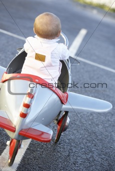 Baby Girl Riding In Toy Aeroplane
