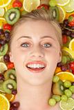 Portrait Of Young Woman Surrounded By Fruit
