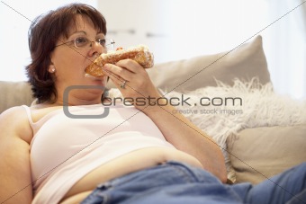 Overweight Woman Relaxing On Sofa