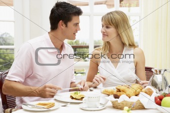 Young Couple Enjoying Hotel Breakfast
