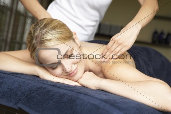Young Woman Enjoying Hot Stone Treatment