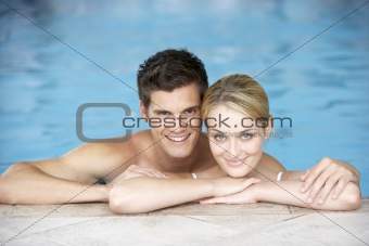 Young Couple Swimming In Pool