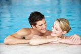 Young Couple Swimming In Pool