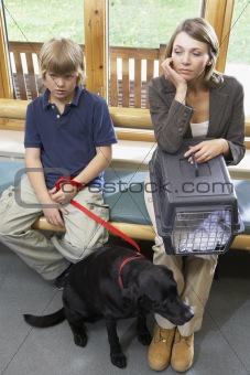 Owners Sitting In Vets Reception Area