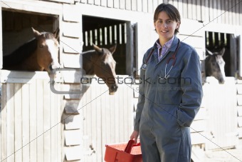 Portrait Of Vet Standing By Horse Stables
