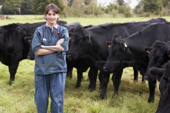 Portrait Of Vet In Field With Cattle