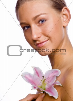 girl with a flower looks into the camera
