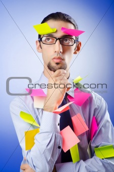 Young businessman with reminder notes