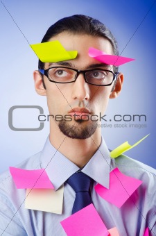 Young businessman with reminder notes