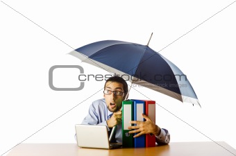 Businessman holding umbrella in the office