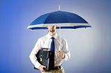 Businessman holding umbrella in the office
