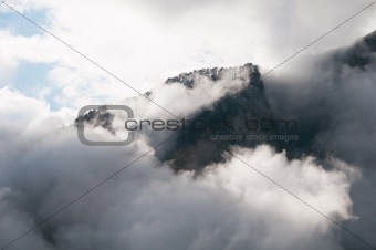 Mountain peak shrouded in clouds