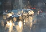 city cars driving in a rain