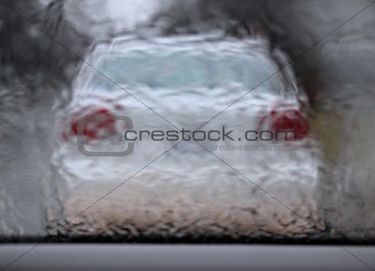 white car driving in a rain 2
