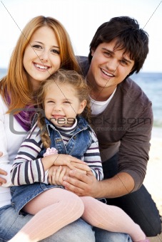 Young family at the beach in fall.