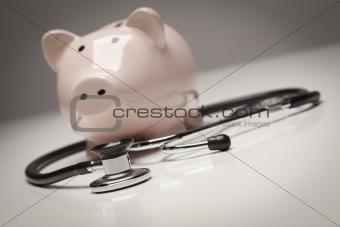 Piggy Bank and Stethoscope with Selective Focus on a Gradated Background.