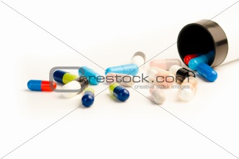 Colored pills on white background