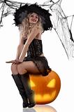 sexy witch sitting on a pumpkin