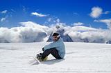 Snowboarder resting on the ski slope