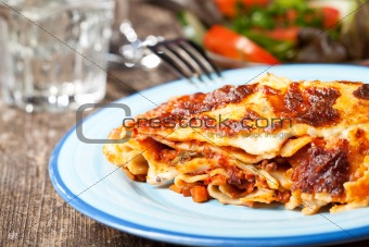 fresh lasagna dish on a blue plate