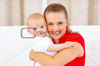 Portrait of lovely baby and young mother

