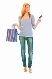 Full length portrait of attractive teen girl with shopping bags and credit card
