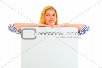 Pretty teen girl with blank billboard
