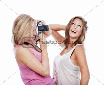 two young women taking pictures of each other - isolated on white