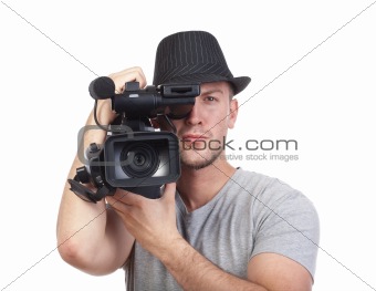 professional videographer in hat holding a camera - isolated on white
