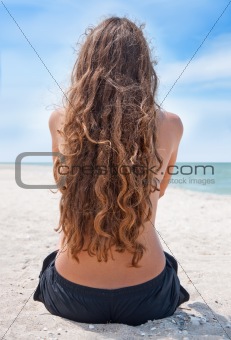 Beautiful young woman relaxing near the sea 
