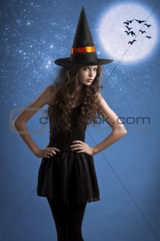 sweet halloween witch posing under the stars