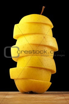 Yellow apple tower on a black background