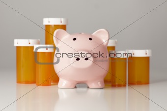 Piggy Bank In Front of Several Medicine Bottles on a Gradated Background.