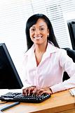 Happy black businesswoman at desk